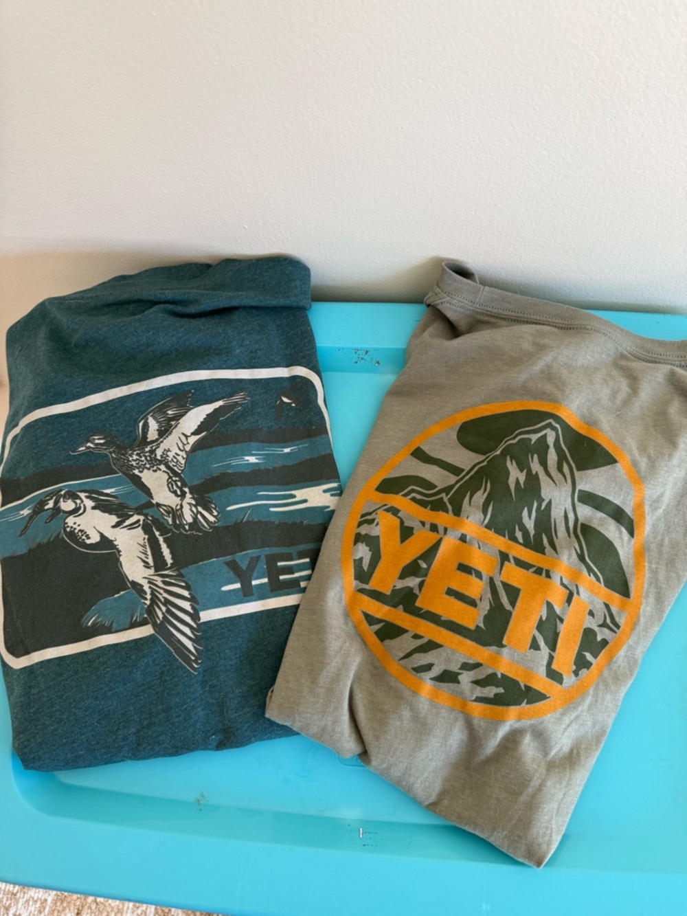 Yeti Pet Fish Graphic Tees in Teal and Khaki with Orange Accent